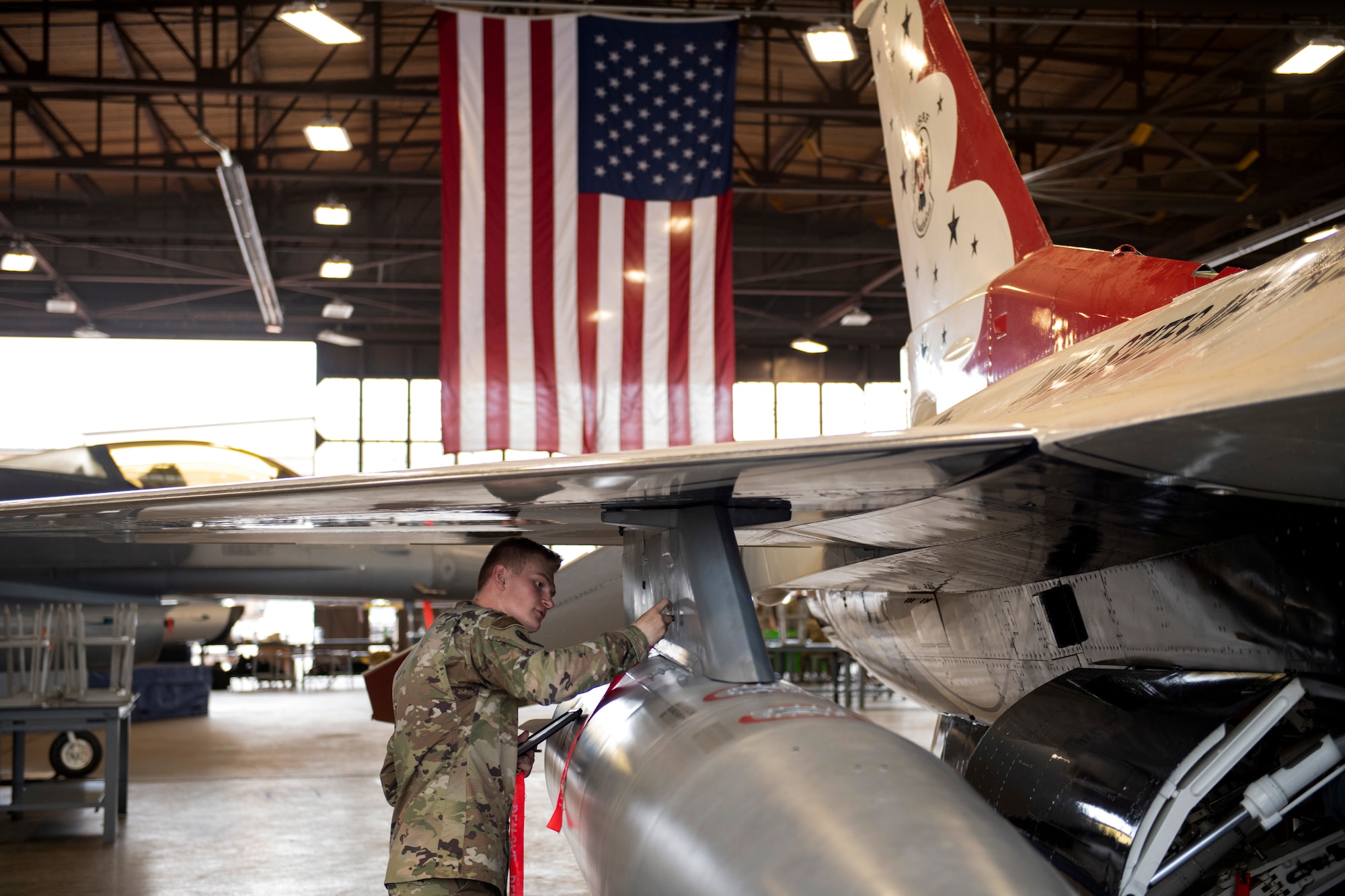 Airman performs safe-for-maintenance check on F-16