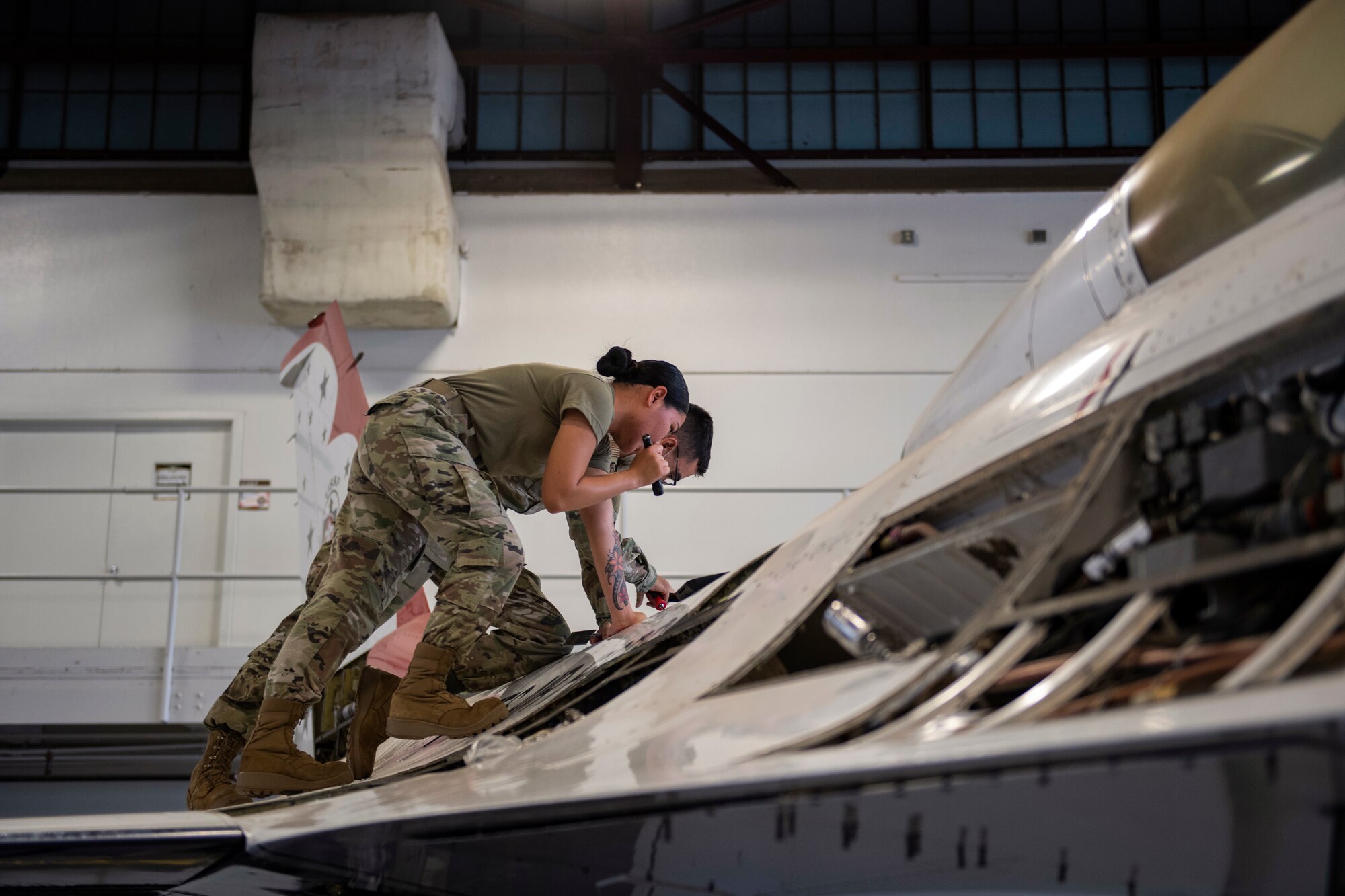 Airmen check aerial refuel door on F-16