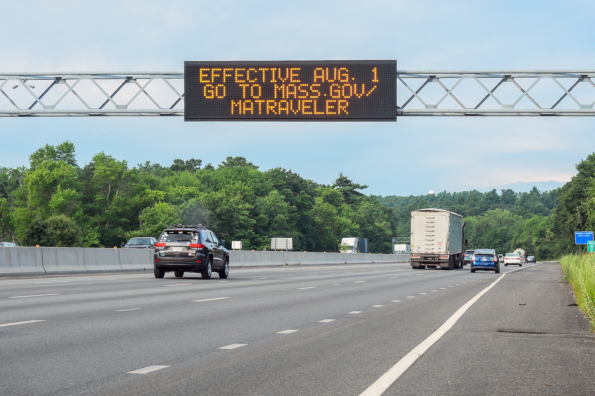 A digital sign above Route 128 announces the Massachusetts' new travel order July 31. As a result, base officials updated the Hanscom Travel Policy.