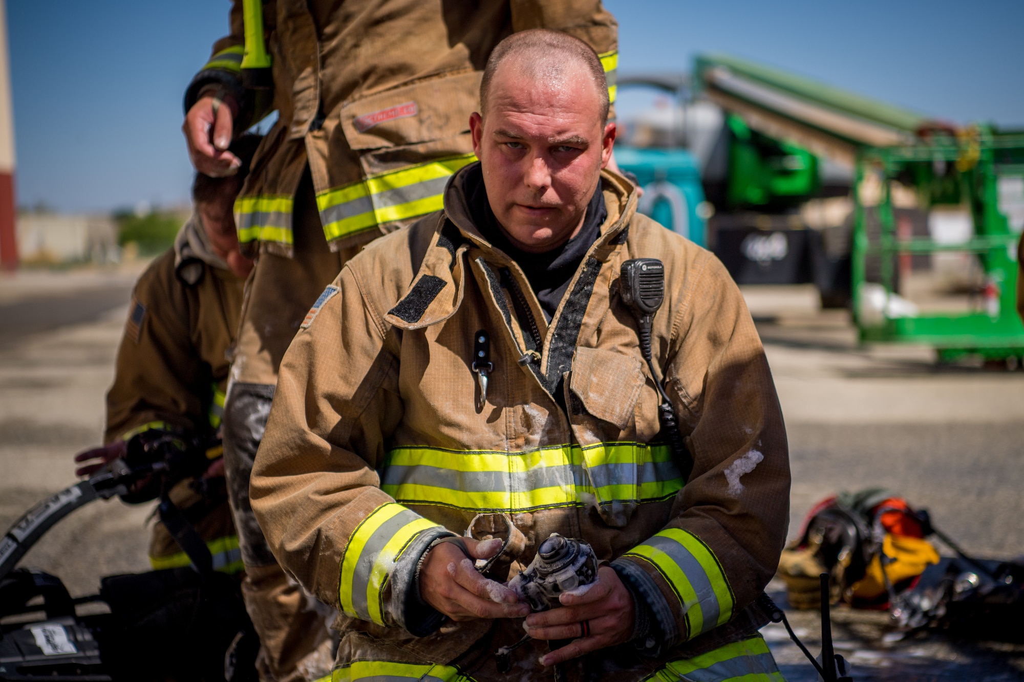 Firefighter John Templeton takes a break following search and rescue training at a recently remodeled hangar at Edwards Air Force Base, California, July 23. Firefighters were tasked locating a simulated victim amidst the fire suppressant foam deployed throughout the hangar. (Air Force photo by Chris Dyer)