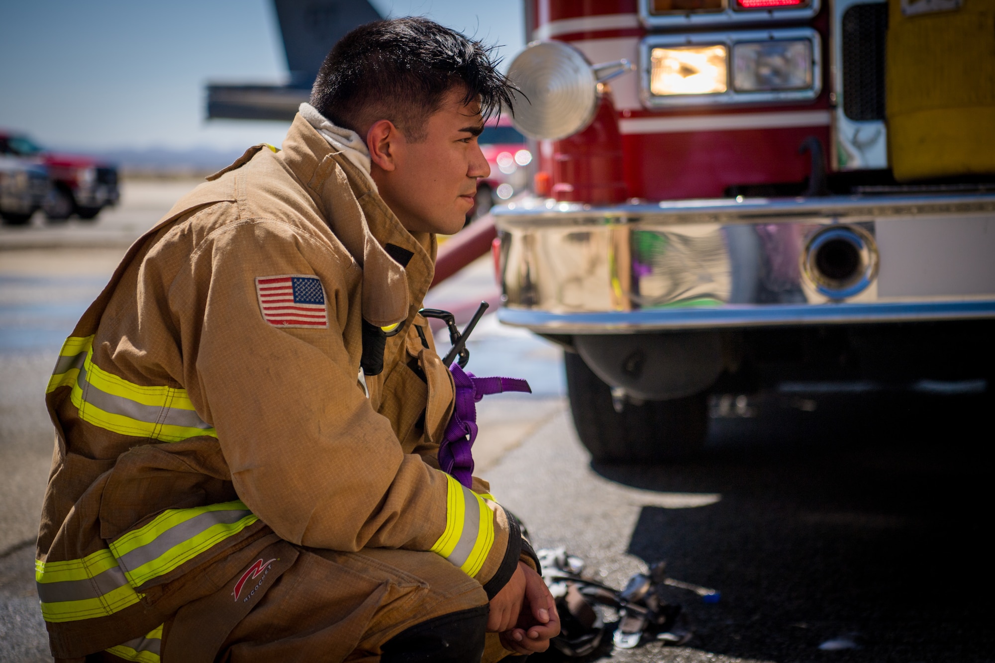 Firefighter Senior Airman Rene Rosas takes a break following search and rescue training at a recently remodeled hangar at Edwards Air Force Base, California, July 23. The unique training opportunity provided the firefighters a mentally and physically demanding training scenario. (Air Force photo by Chris Dyer)