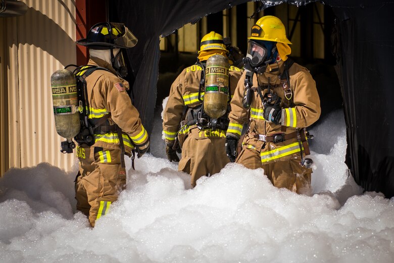 Firefighters from the Edwards Air Force Base Fire and Emergency Services conduct search and rescue training at a recently remodeled hangar at Edwards Air Force Base, California, July 23. Firefighters were tasked with locating a simulated victim amidst the fire suppressant foam deployed throughout the hangar. (Air Force photo by Chris Dyer)
