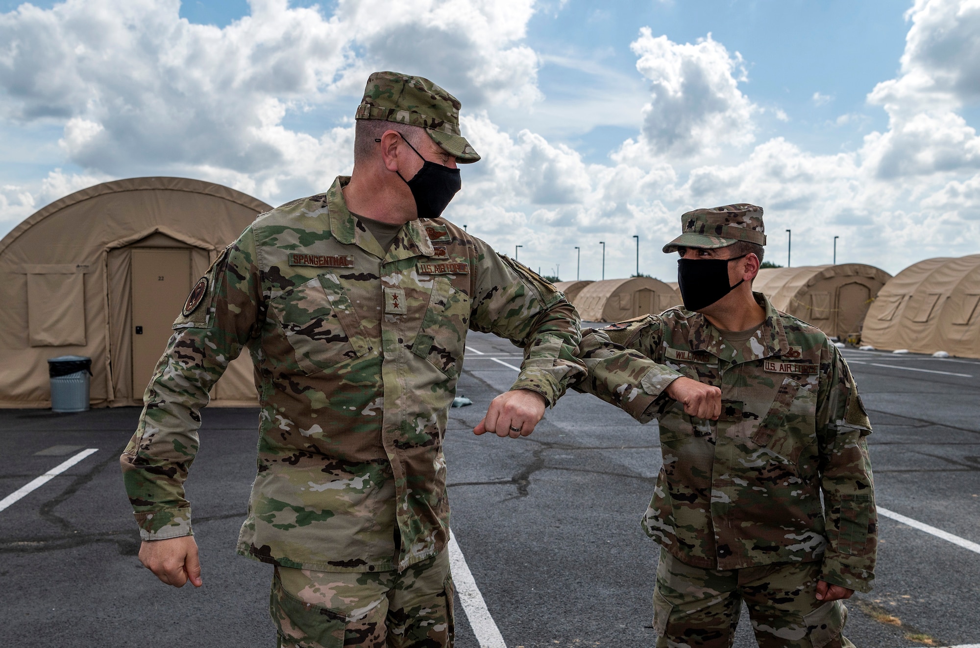 Maj. Gen. William Spangenthal, vice commander of Air Education and Training Command, elbow bumps Lt. Col. Damien Williams, 37th Training Group deputy commander, during an immersion tour June 24, 2020, at JBSA-Lackland, Texas.