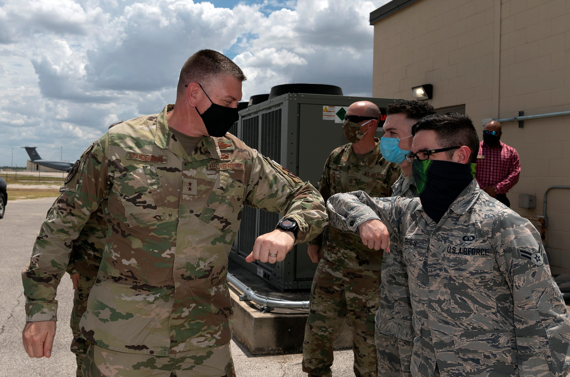 Maj. Gen. William Spangenthal, vice commander of Air Education and Training Command, elbow bumps Lt. Col. Damien Williams, 37th Training Group deputy commander, during an immersion tour June 24, 2020, at JBSA-Lackland, Texas.