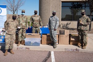 Airmen from the 17th Test Squadron, 50th Security Forces Squadron and the 4th Space Operations Squadron volunteered at a school liaison hosted back-to-school drive July 31, 2020, at Schriever Air Force Base, Colorado. The Airmen handed out school supplies to families. (U.S. Air Force photo by Airman 1st Class Jonathan Whitely)