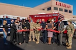 Group gathers and cuts ribbon.