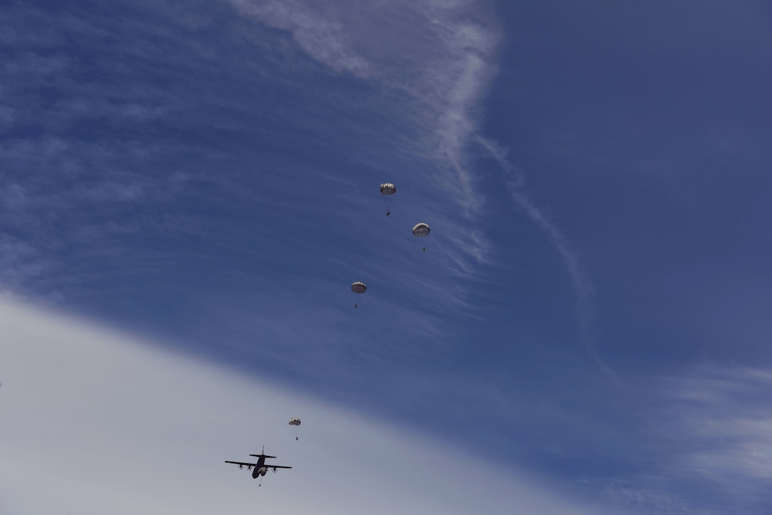 U.S. Airmen assigned to the 435th Security Forces Squadron and 435th Contingency Response Squadron jump from a C-130J Super Hercules