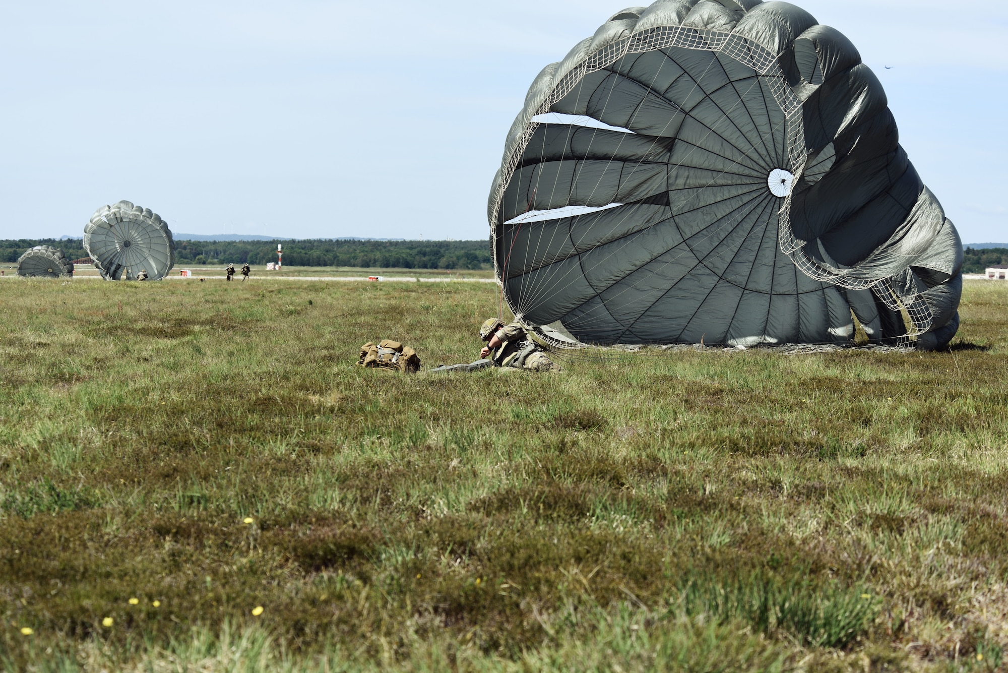 U.S. Air Force Staff Sgt. Kyle Volentine, 435th Contingency Response Group jumpmaster, lands in a field after jumping out of a C-130J Super Hercules during exercise Agile Wolf 20-04.