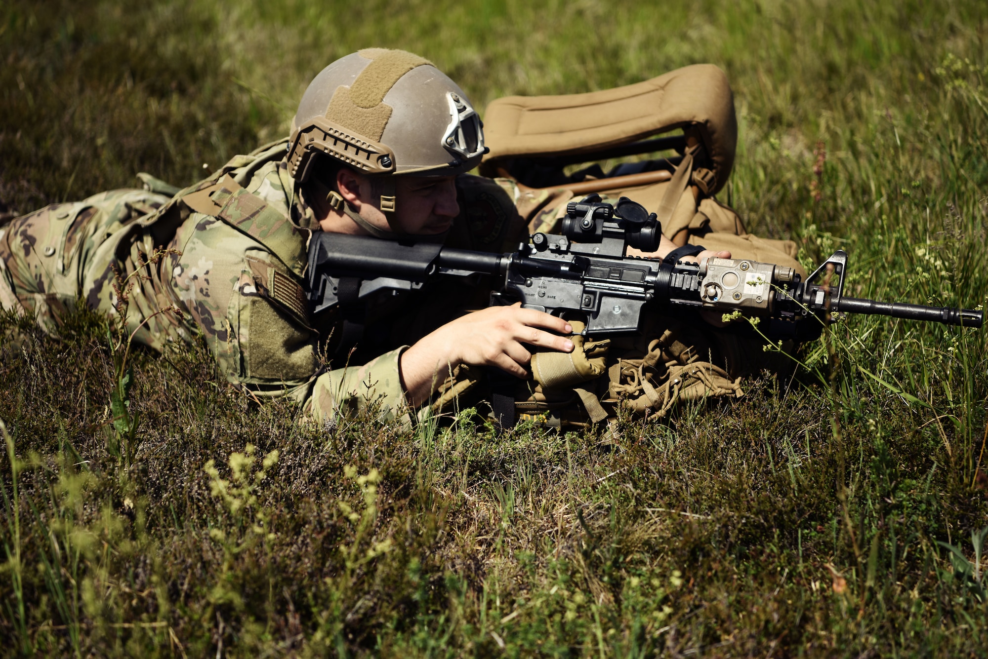 A U.S. Airman assigned to the 435th Contingency Response Group holds an M-4 carbine assault rifle while securing a landing zone during exercise Agile Wolf 20-04.