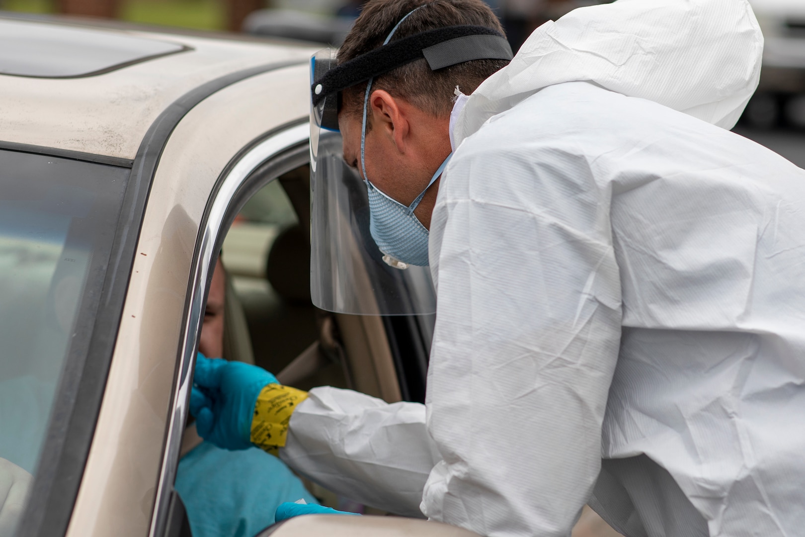 A North Carolina Army National Guard Soldier assigned to the 42nd Civil Support Team gathers test samples while supporting local health and emergency officials at a drive-thru COVID-19 test site in Sanford, North Carolina, May 28, 2020. More than 900 NCNG Soldiers and Airmen have been activated in response to COVID-19 relief efforts.