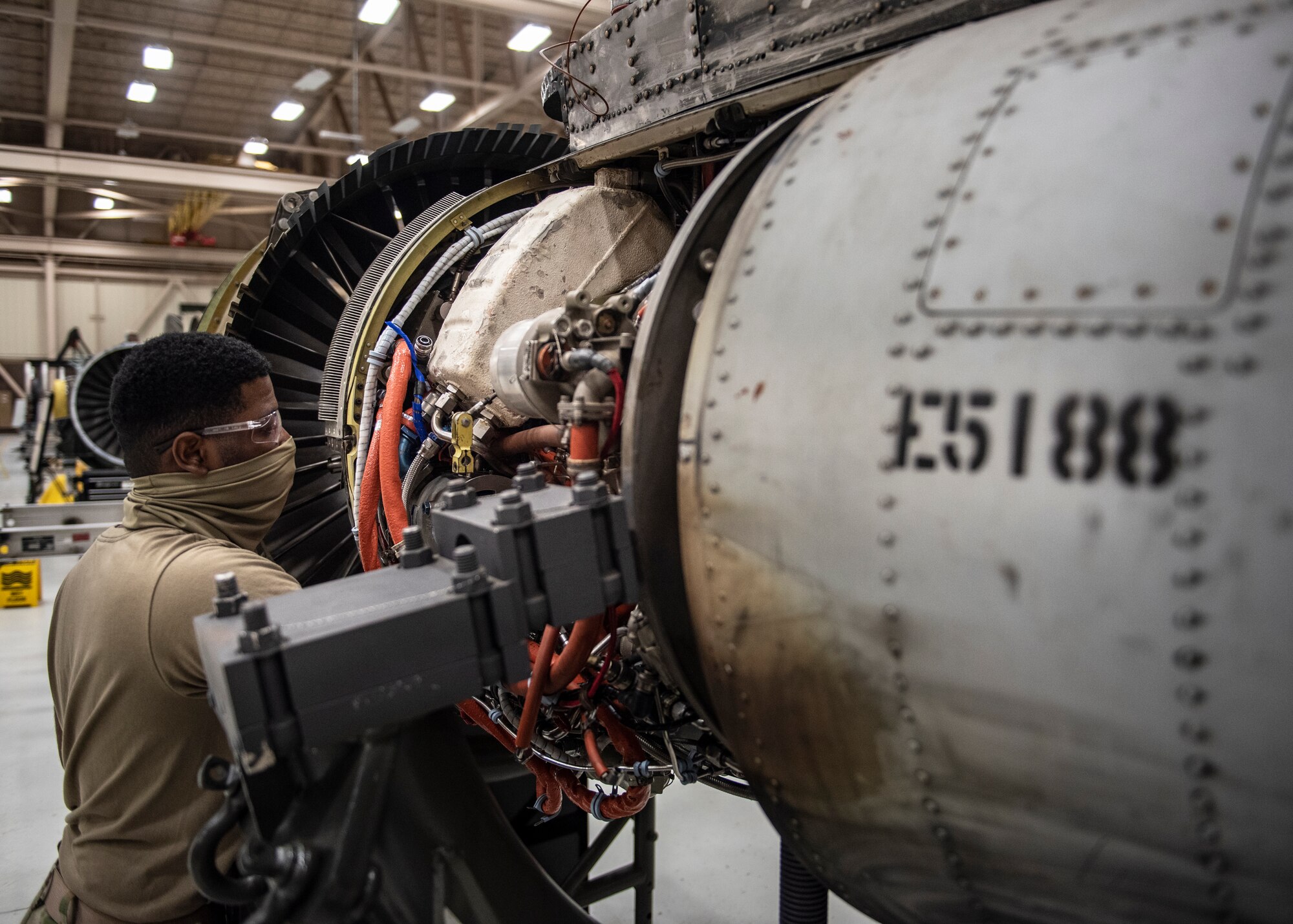 A 361st Training Squadron aerospace propulsion student wears a mask during training as precautions for the COVID-19 virus at Sheppard Air Force Base, Texas, June 1, 2020. The student is working on an aircraft engine. (U.S. Air Force photo by Senior Airman Pedro Tenorio)