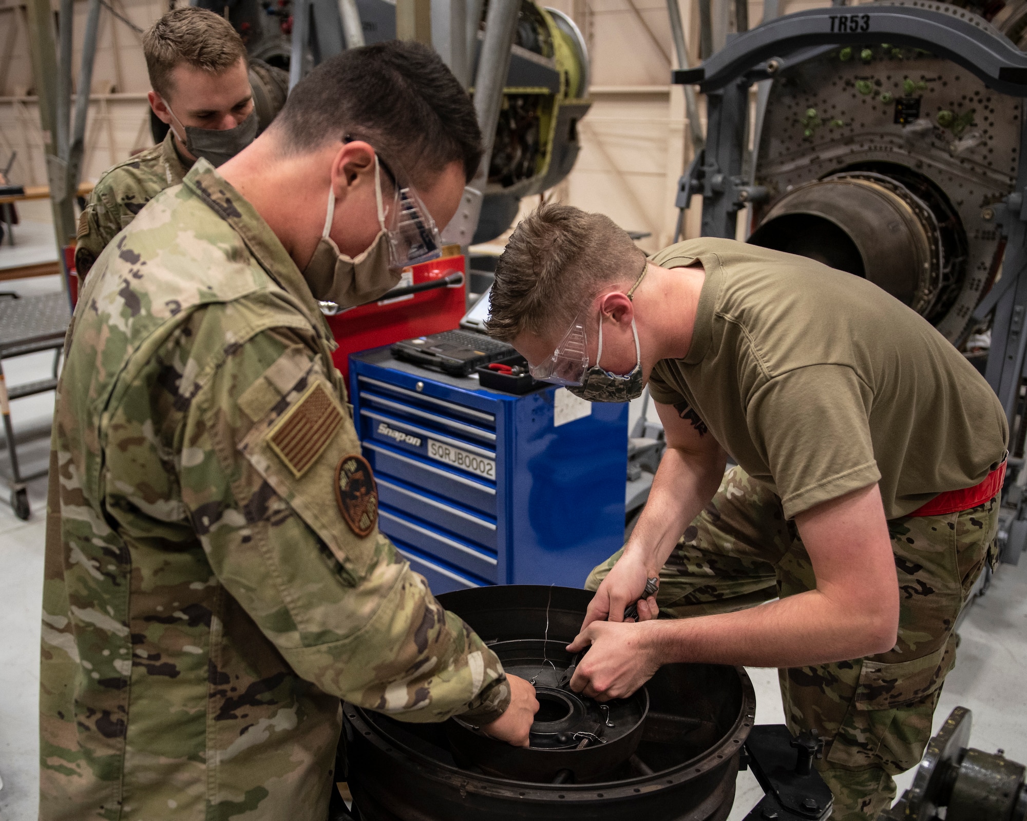 361st Training Squadron aerospace propulsion students wear masks during training as precautions for the COVID-19 virus at Sheppard Air Force Base, Texas, June 1, 2020. The students are working on a turbine rear bearing. (U.S. Air Force photo by Senior Airman Pedro Tenorio)