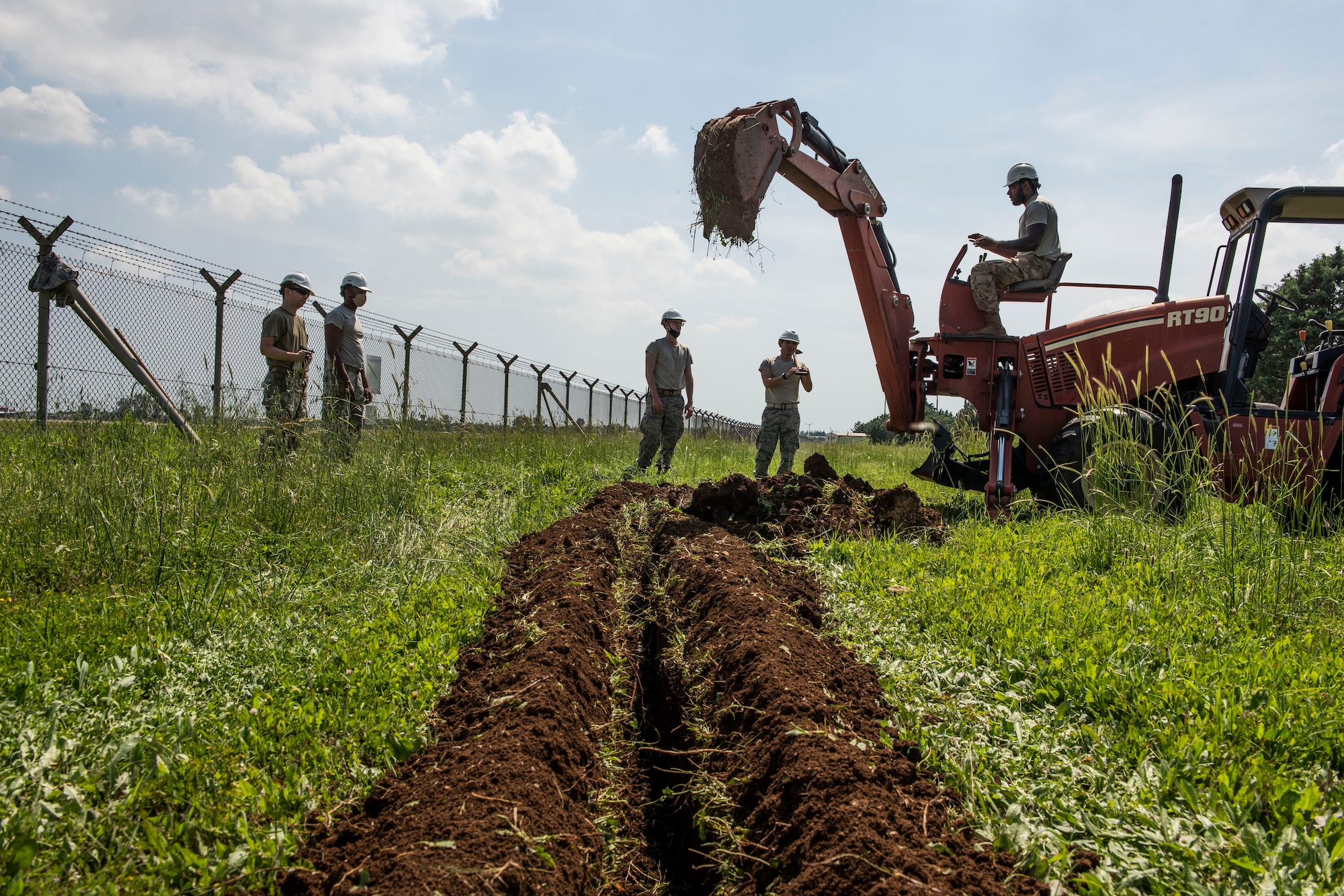 Photo of Airmen digging a trench