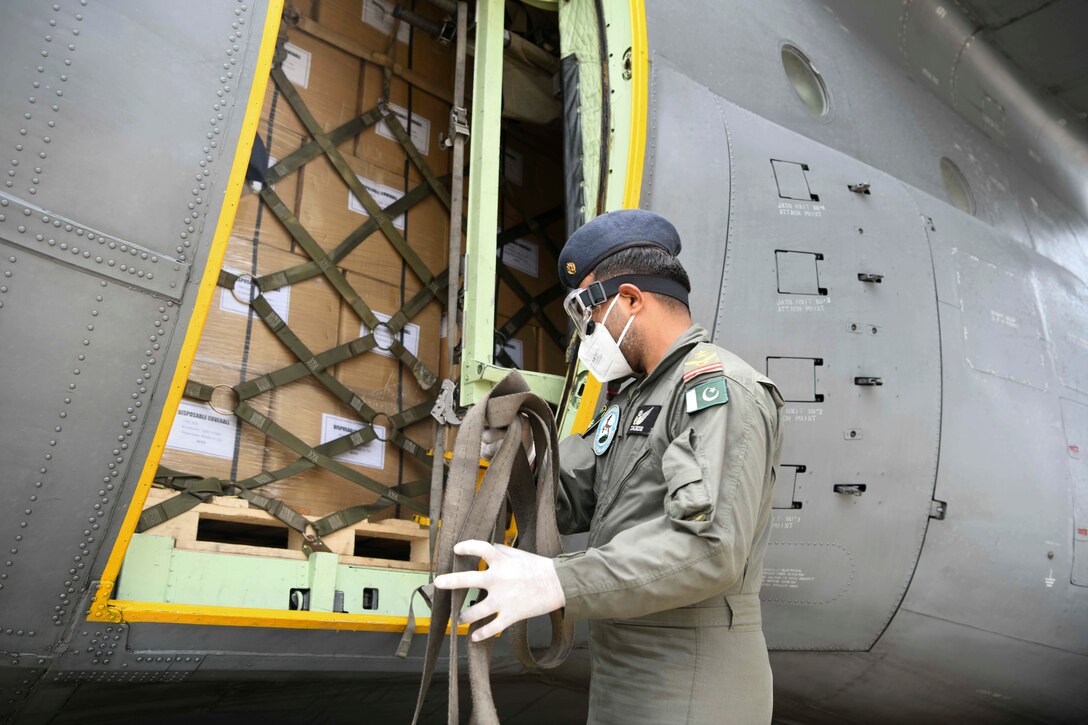 A Pakistani aircrew member collecting straps.