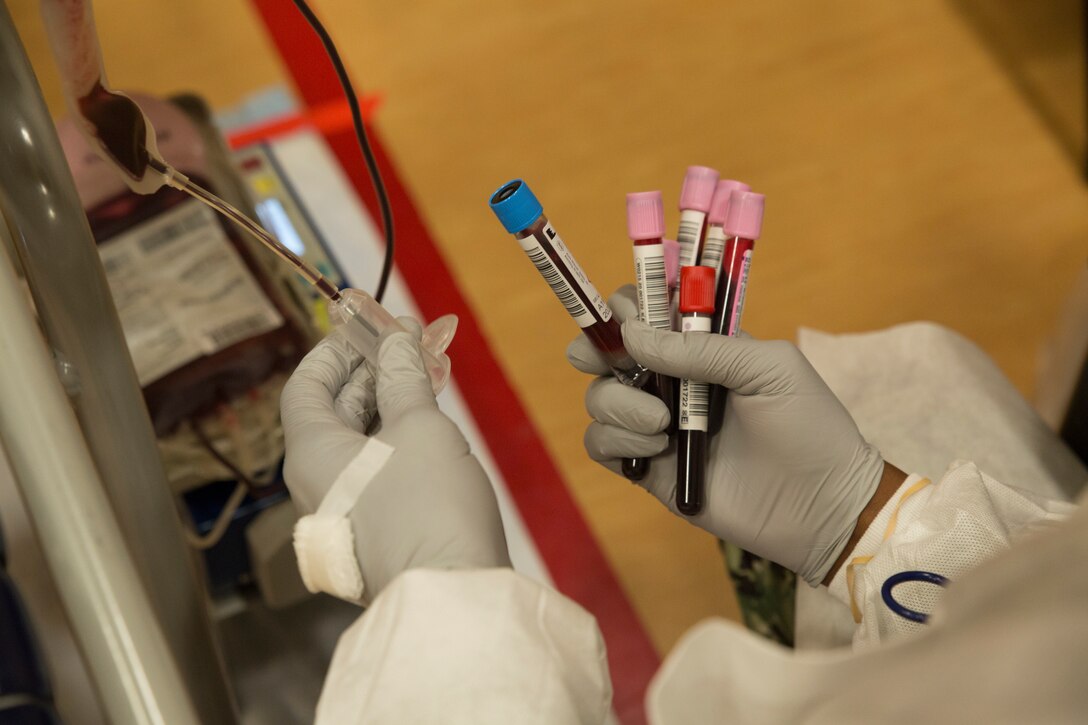 A U.S. Navy corpsman holds a vacutainer blood collection tube containing blood during an Armed Services Blood Program (ASBP) blood drive at Hopkins Gymnasium on Camp Elmore, Norfolk, Virginia, May 28, 2020. Despite the Coronavirus Disease 2019 (COVID-19) pandemic, ASBP and leaders with Headquarters and Service Battalion, U.S. Marine Corps Forces Command, Fleet Marine Force Atlantic, coordinated this event to help support the ASBP in their critical mission of blood collection, manufacturing and transfusion of the U.S. military. (U.S. Marine Corps Photo by Lance Cpl. Jack Chen)