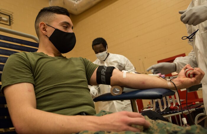 U.S. Marine Sgt. Francisco Ortiz, a financial management resource analyst with Headquarters and Service Battalion, U.S. Marine Corps Forces Command, donates blood during an Armed Services Blood Program (ASBP) blood drive at Hopkins Gymnasium on Camp Elmore, Norfolk, Virginia, May 28, 2020.