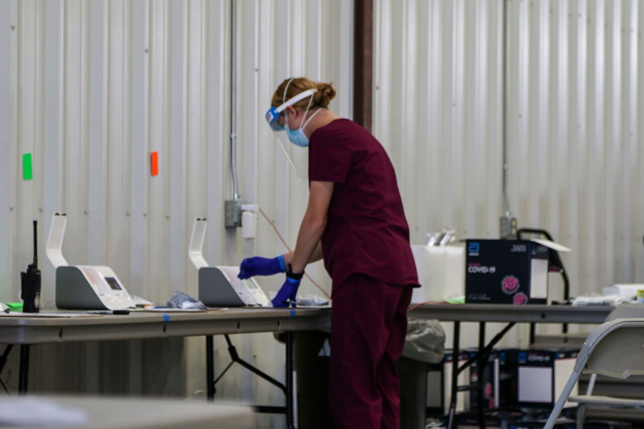 Kansas guardsmen conducting COVID-19 screenings.