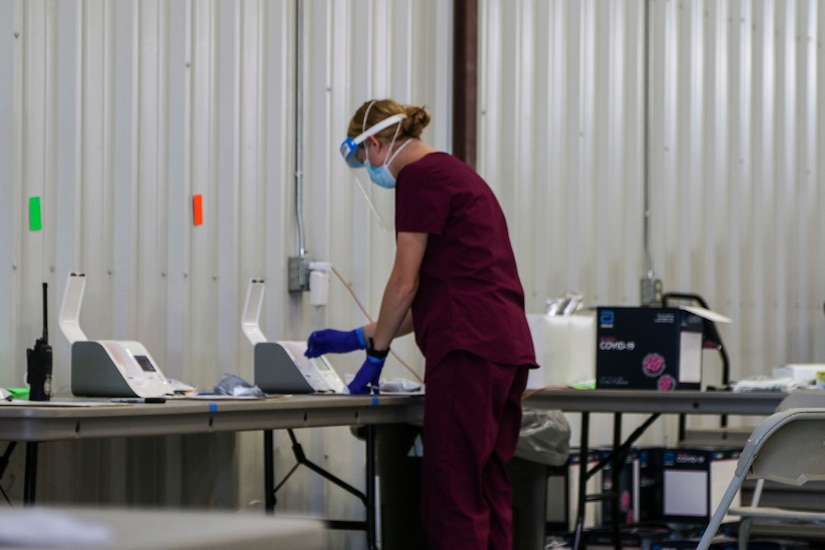 Kansas guardsmen conducting COVID-19 screenings.