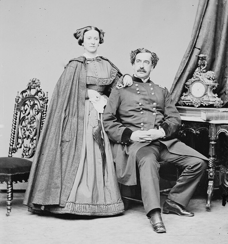 A mid-19th century couple pose for a portrait.