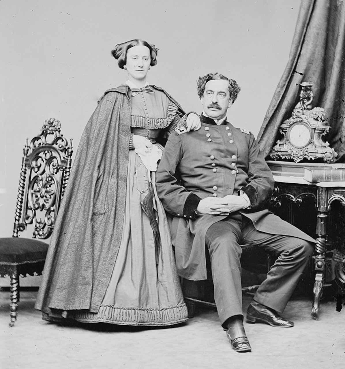 A mid-19th century couple pose for a portrait.