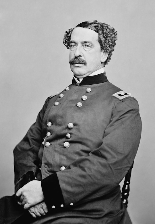 A man in a Civil War-era uniform poses for a portrait.