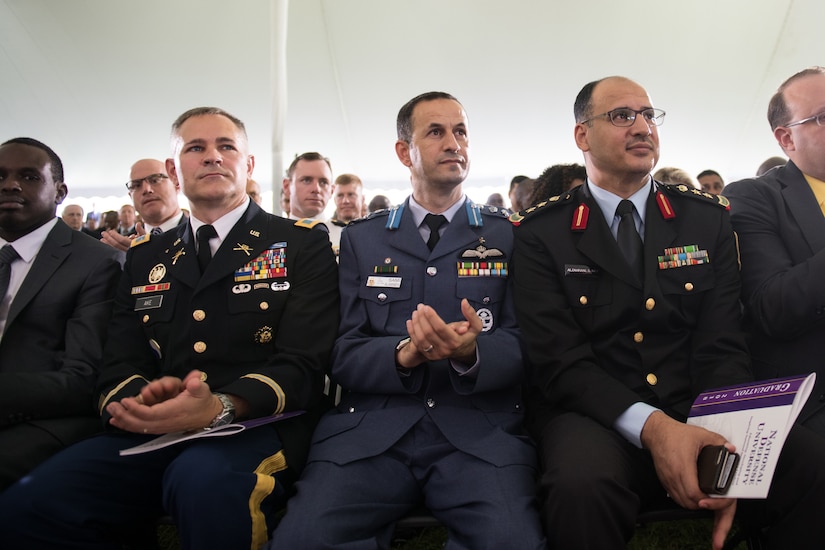 U.S. and allied officers sit together.