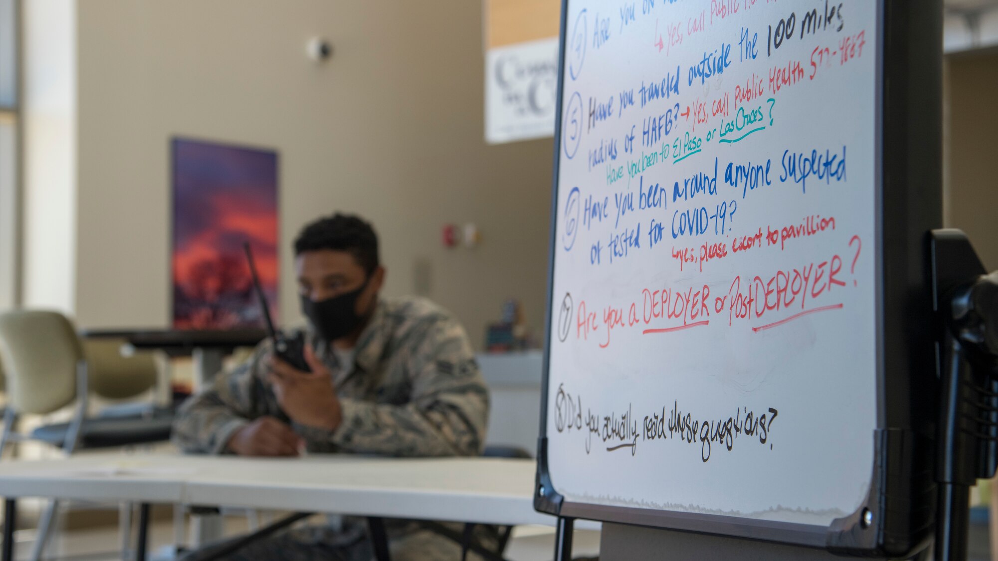 A COVID-19 pre-screening questionnaire board is displayed, May 27, 2020, at the 49th Medical Group entrance on Holloman Air Force Base, N.M. 49th MDG volunteers manned the front entrance of the clinic to provide a COVID-19 prescreening questionnaire for personnel accessing the hospital, to ensure members are kept safe and informed on COVID-19 procedures and protocols. (U.S. Air Force photo by Senior Airman Collette Brooks)