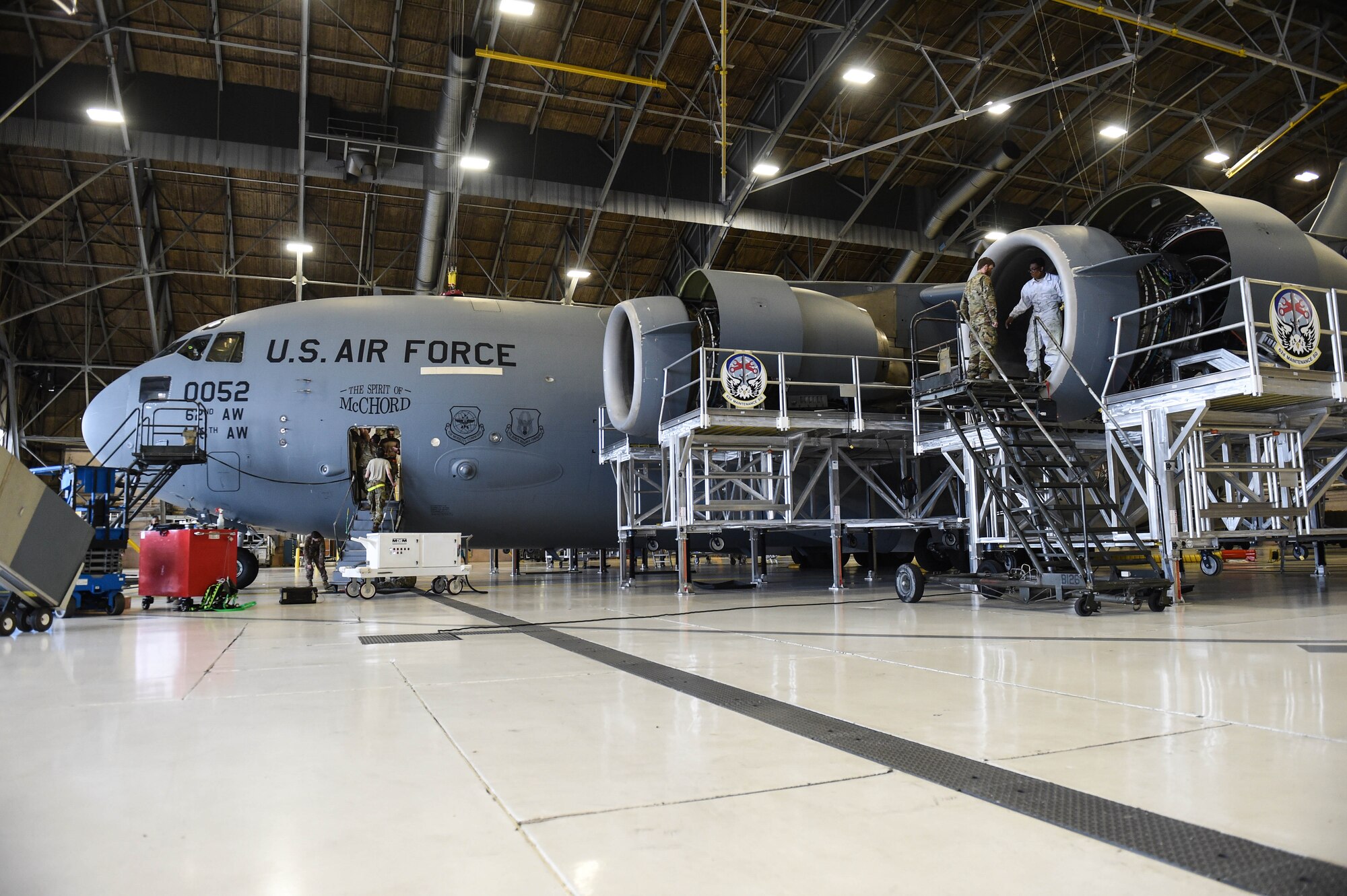 Airmen in the 62nd Maintenance Squadron conduct a home station check on a C-17 Globemaster III inside a hangar on Joint Base Lewis-McChord, Wash., May 20, 2020. Every 180 days a C-17 receives a home station check, during which it undergoes a thorough safety and functionality inspection. (U.S. Air Force photo by Airman 1st Class Mikayla Heineck)