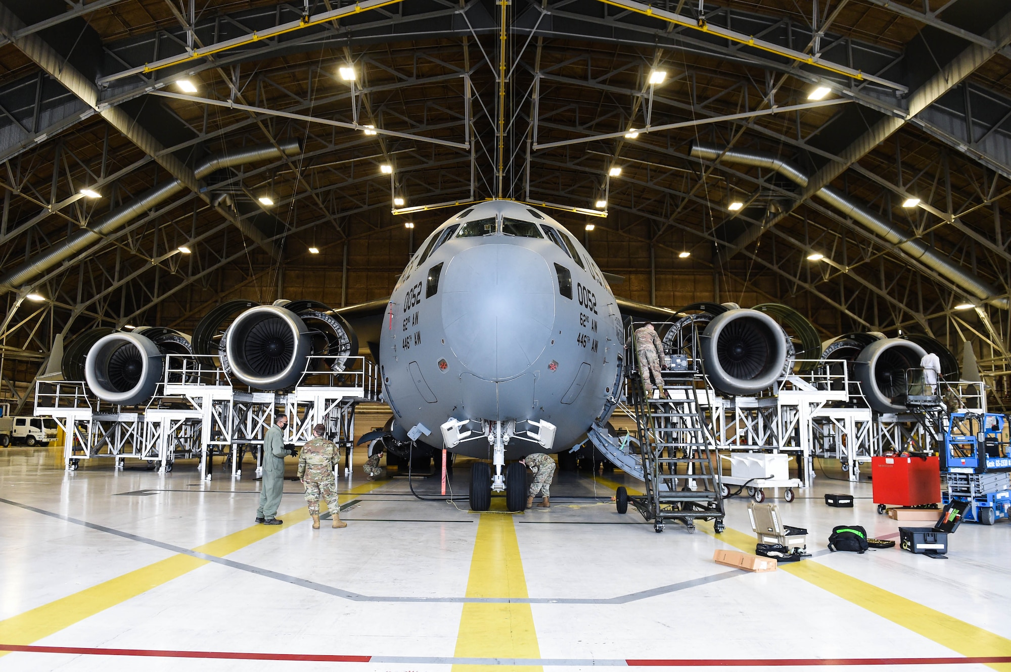 Airmen in the 62nd Maintenance Squadron conduct a home station check on a C-17 Globemaster III inside a hangar on Joint Base Lewis-McChord, Wash., May 20, 2020. Every 180 days a C-17 receives a home station check, during which it undergoes a thorough safety and functionality inspection. (U.S. Air Force photo by Airman 1st Class Mikayla Heineck)