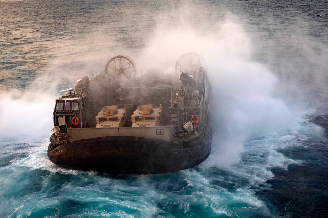 An air-cushioned landing craft travels through waters.