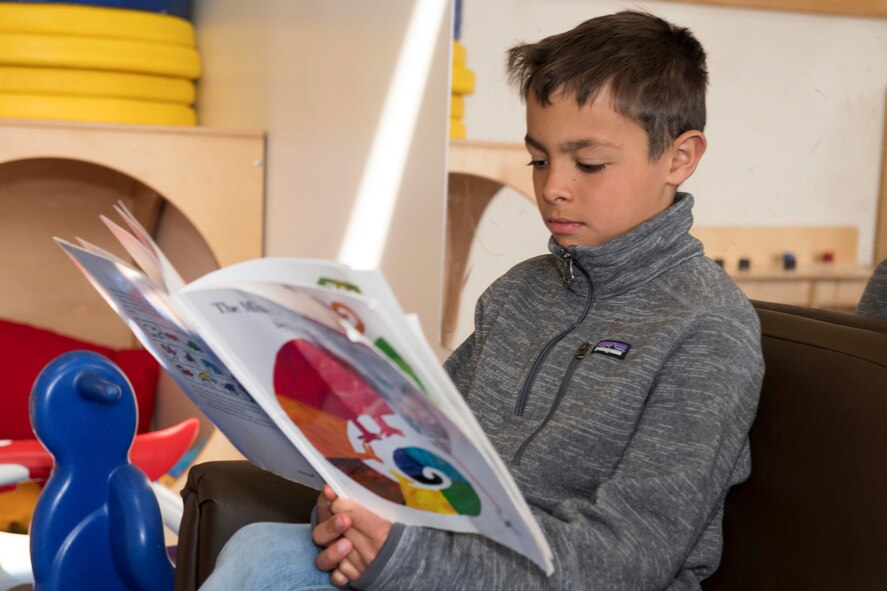 A child reads a book at a daycare