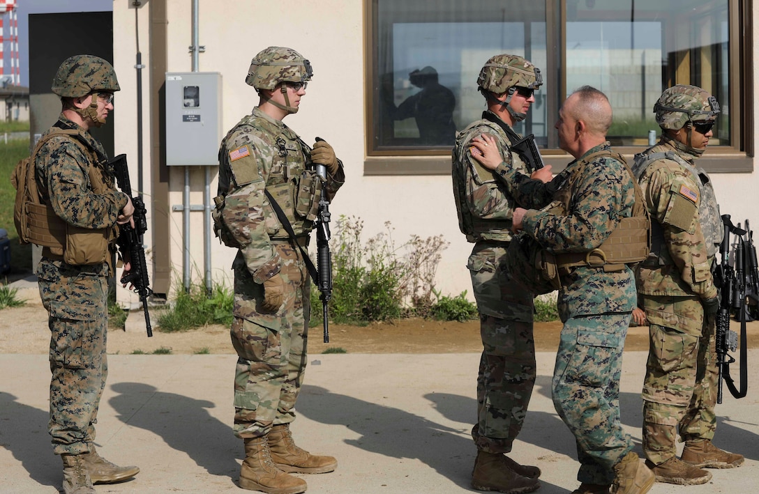 Marines from U.S. Marine Corps Forces Korea were invited to train alongside the 557th Military Police Company here on Camp Humphreys, South Korea, May 27. The joint training allowed the Marines and Soldiers to practice their marksmanship and maintain their overall readiness. (U.S. Marine Corps Photo by Sgt. Parker R. Golz)