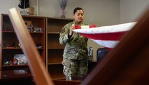 U.S. Air Force Master Sgt. Stephanie Beil, the 354th Force Support Squadron operations flight superintendent, folds a flag at Eielson Air Force Base, Alaska, June 1, 2020. Beil recently won Pacific Air Forces Force Support Squadron Senior Noncommissioned Officer of the Year at the installation level.(U.S. Air Force photo by Staff Sgt. Sean Martin)