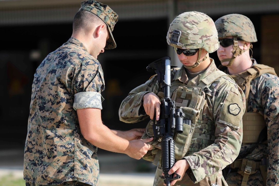 Marines from U.S. Marine Corps Forces Korea were invited to train alongside the 557th Military Police Company here on Camp Humphreys, South Korea, May 14. The joint training allowed the Marines and Soldiers to practice their marksmanship and maintain their overall readiness. (U.S. Marine Corps Photo by Sgt. Parker R. Golz)