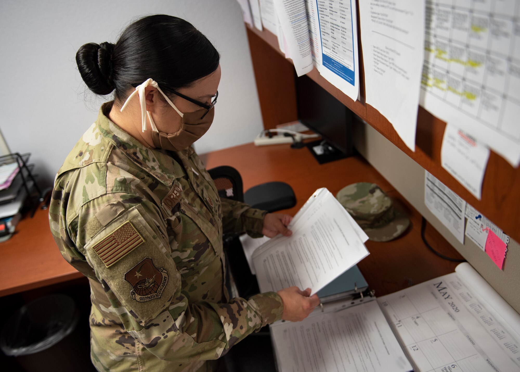 Tech. Sgt. Sara Moreno puts patient's form in binder