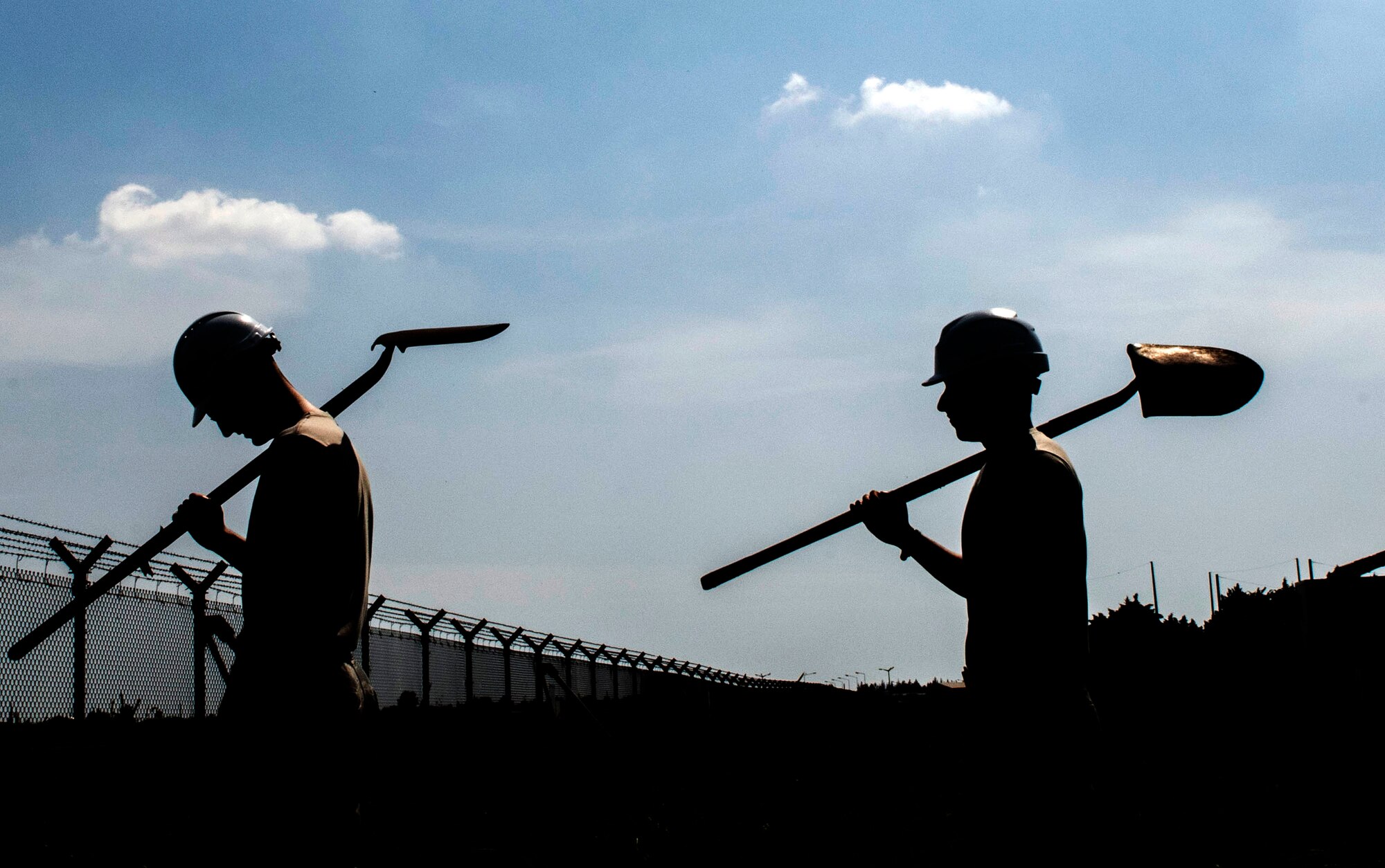 “Cable dawgs” assigned to the 39th Communications Squadron carry their shovels after an afternoon of work May 11, 2020, at Incirlik Air Base, Turkey. Cable and antenna systems Airmen, popularly called “cable dawgs,” are often mistaken for civil engineers because their jobs take place outdoors and involve vigorous manual labor. (U.S. Air Force photo by Staff Sgt. Joshua Magbanua)