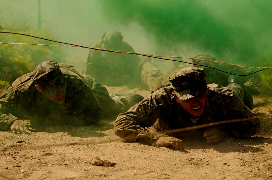 Special Warfare Combatant-Craft Crewman candidates from Basic Crewman Selection Class 111 low-crawl under obstacle during “The Tour” at Naval Special Warfare Center in Coronado, California, June 1, 2020 (U.S. Navy/Anthony W. Walker)