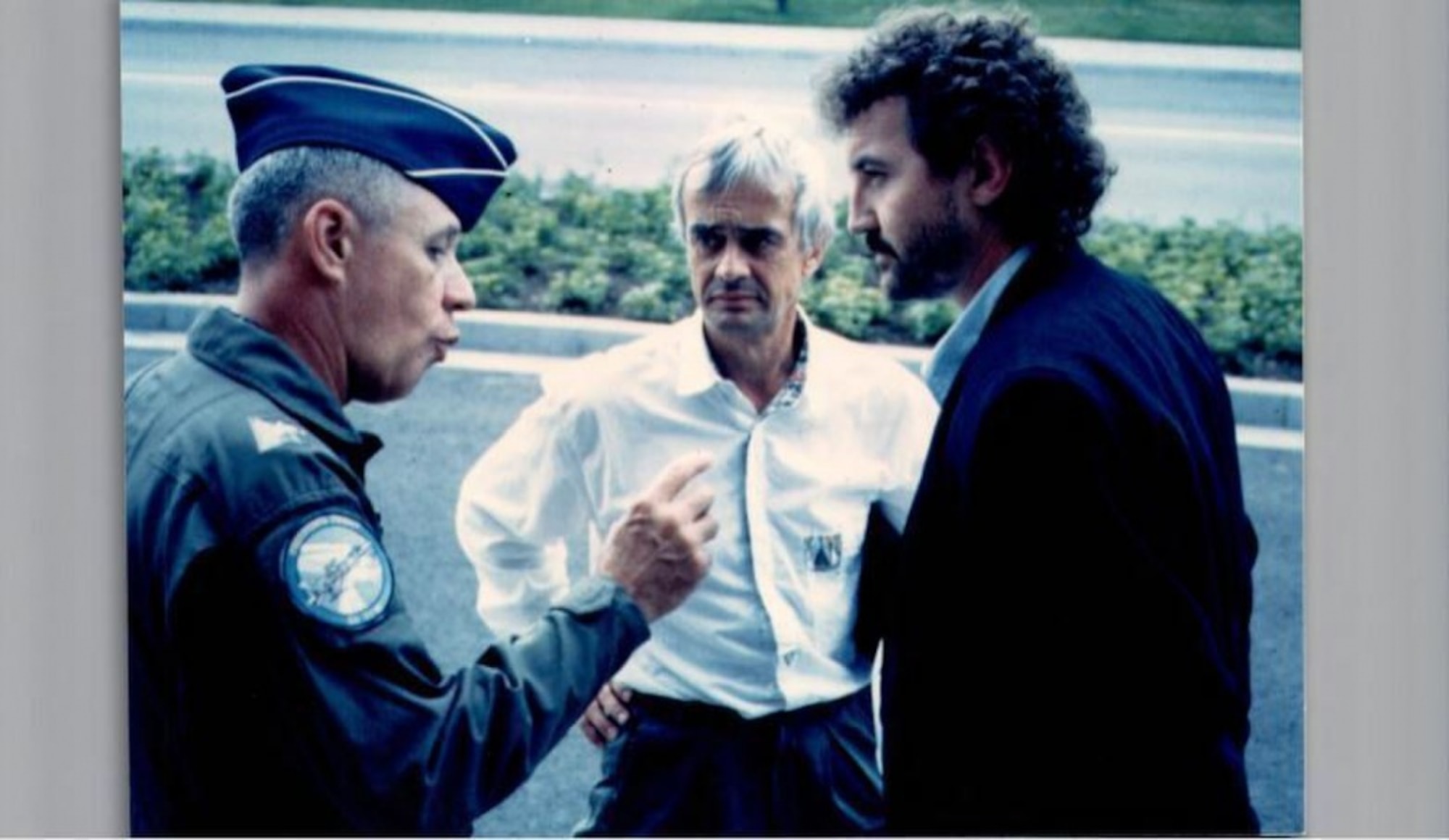 Mr. Rainer Mueller (right), 86th Civil Engineer Squadron installation management flight chief, speaks with his wing commander at Ramstein Air Base, Germany, in 1990. Throughout his career, Mueller, a local national, was responsible for all environmental, property and support agreements within the Kaiserslautern Military Community. (Courtesy photo of Herr Rainer Mueller)