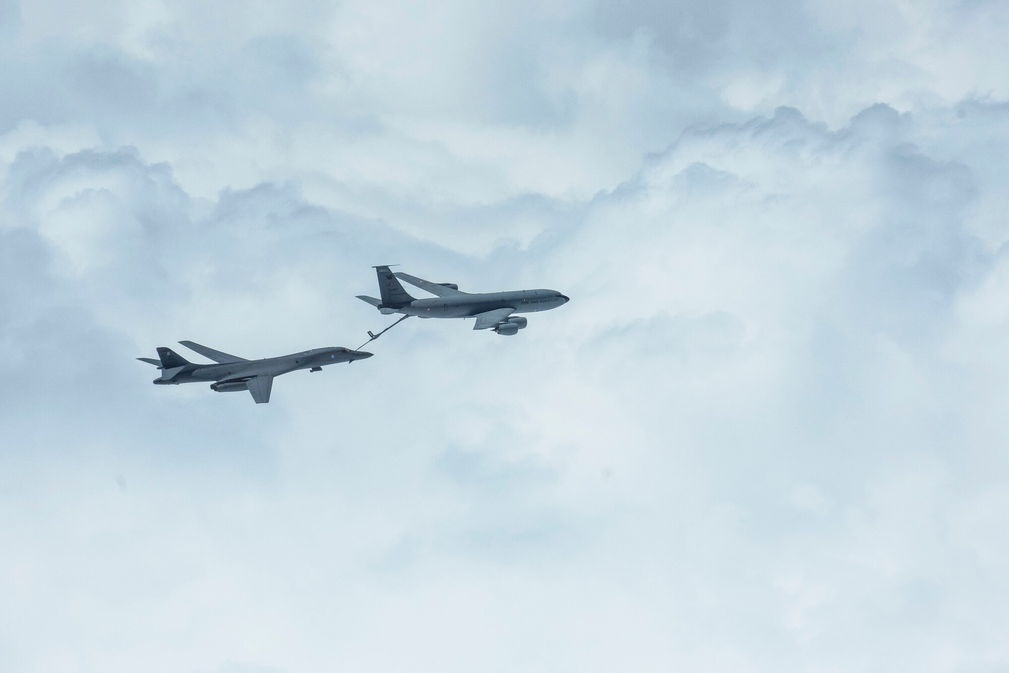 Photo of an aircraft receiving fuel from another aircraft in flight