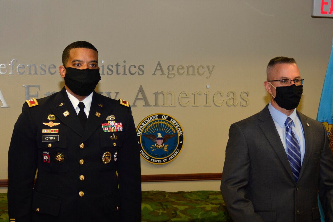 An Army officer and a senior civilian member stand together