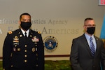 An Army officer and a senior civilian member stand together