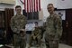 Airman poses with certificate with commander