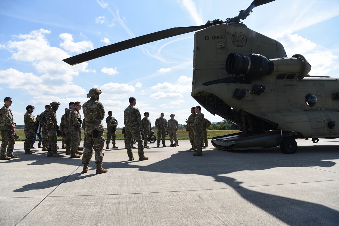 U.S. Army Soldiers assigned to the 1-214th General Support Aviation Battalion, Wiesbaden, Germany, give a CH-47 Chinook helicopter briefing to U.S. Airmen assigned to units within the 435th Contingency Response Group.