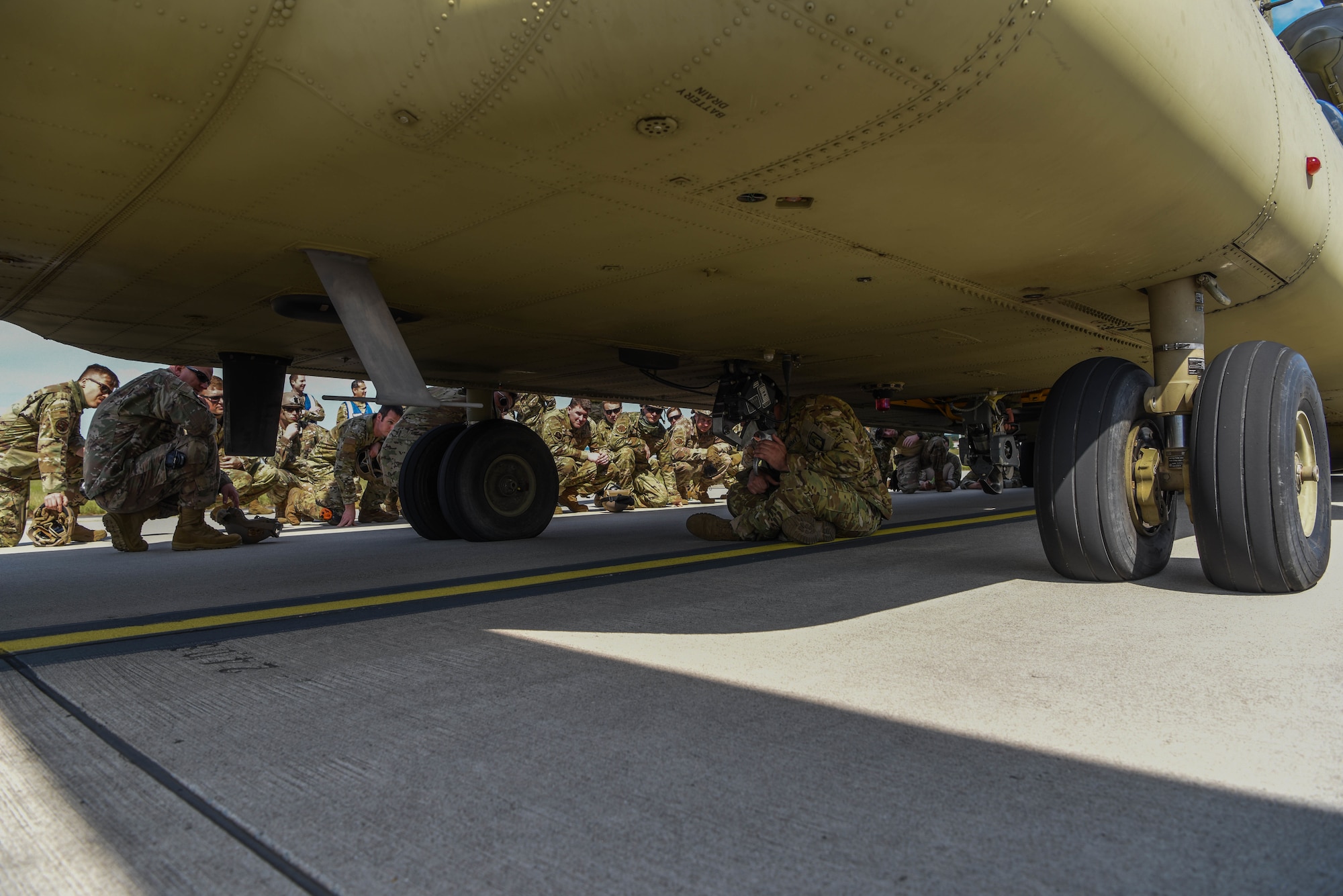 U.S. Army Staff Sgt. Jonathon Alarcon, 1-214th General Support Aviation Battalion, 12th Combat Aviation Brigade CH-47 flight engineer section chief, gives a CH-47 Chinook helicopter briefing to U.S. Airmen assigned to units within the 435th Contingency Response Group.