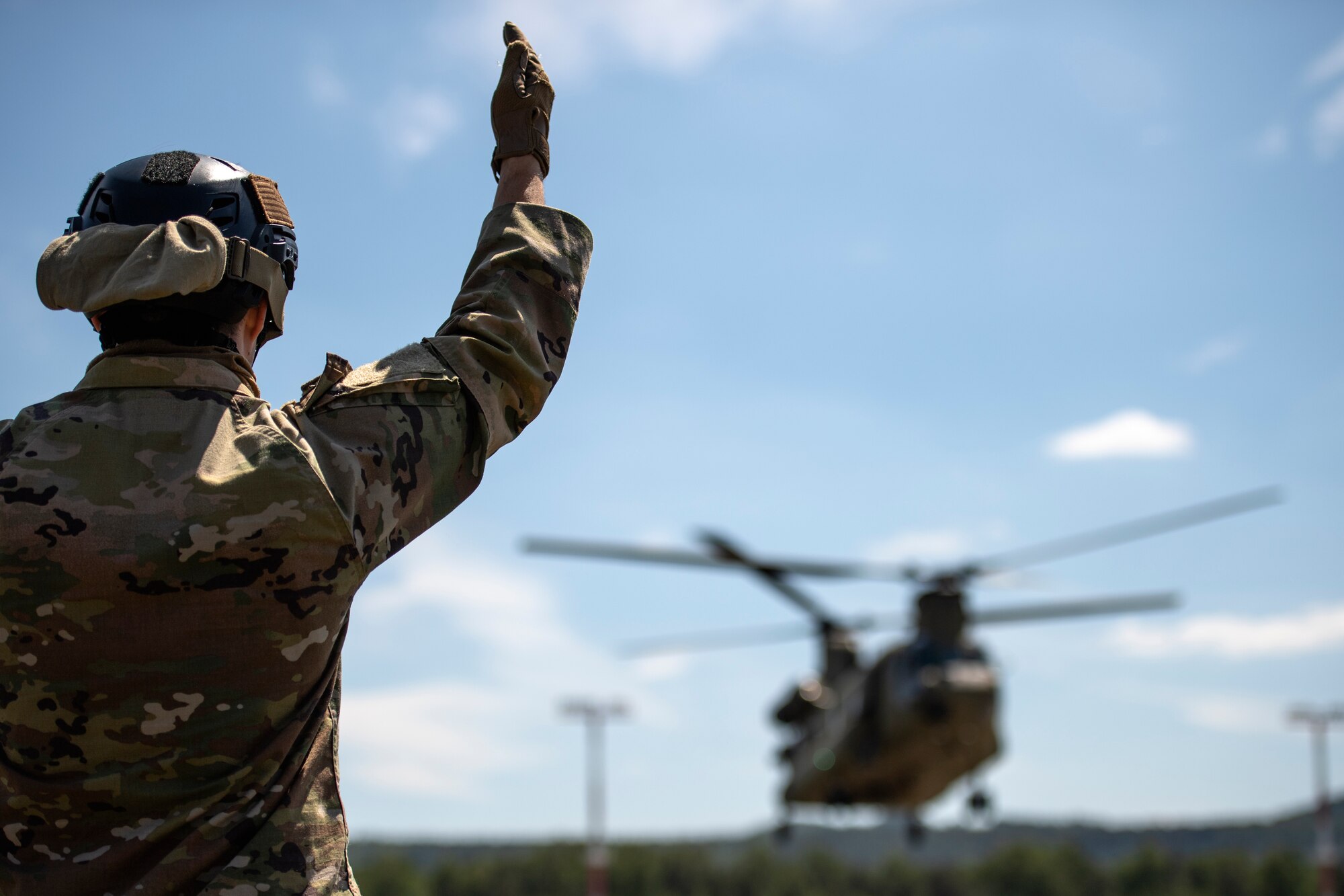 Photo of Airman directing helicopter