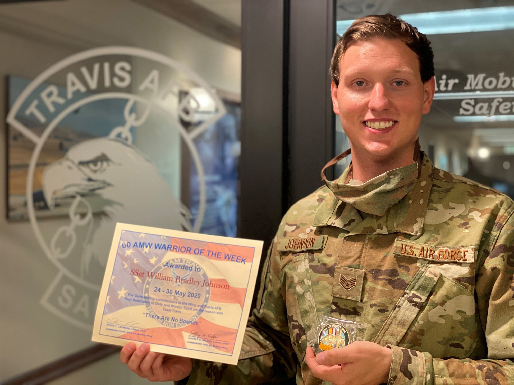 An Airman holds his certificate he received for being the warrior of the week.