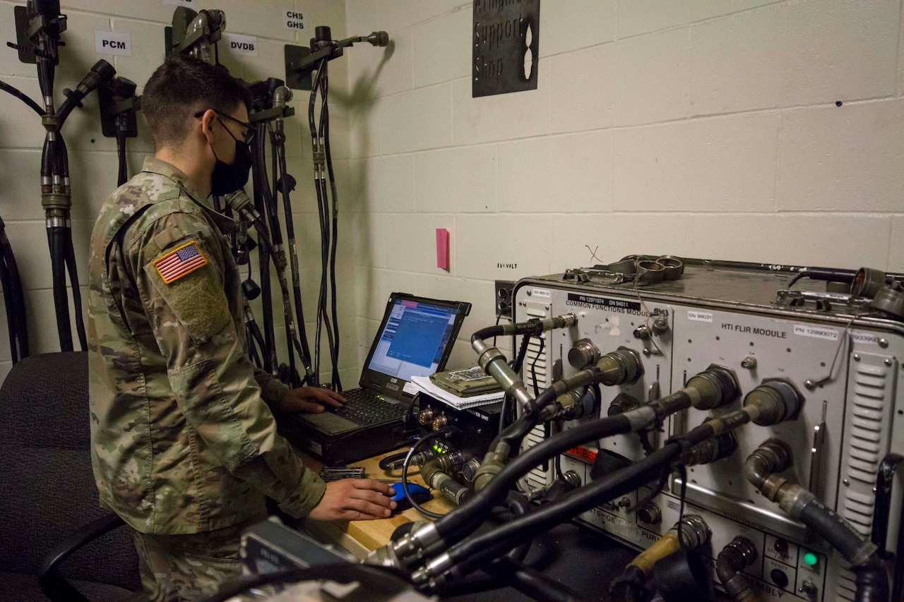 Soldiers working while wearing personal protective equipment.