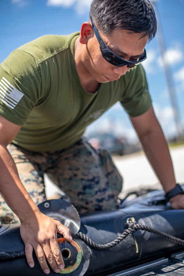 Staff Sgt. Steven Amnatkeolee, a military policeman with Special Purpose Marine Air-Ground Task Force - Southern Command, unscrews a cap to dissemble a combat rubber raiding craft during coxswain training at Camp Lejeune, North Carolina, May 11, 2020. The Marines train and learn small boat skills and procedures to better help the SPMAGTF-SC with mission accomplishment when deployed within jungle environments. These training events assist the Marines and Sailors when working alongside partner nations in Latin America and the Caribbean with crisis response preparedness, security cooperation training, and engineering projects. Amnatkeolee is a native of Anchorage, Alaska. (U.S. Marine Corps photo by Sgt. Andy O. Martinez)