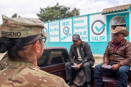 Soldiers visit local city to share information about a free medical event during annual training exercise