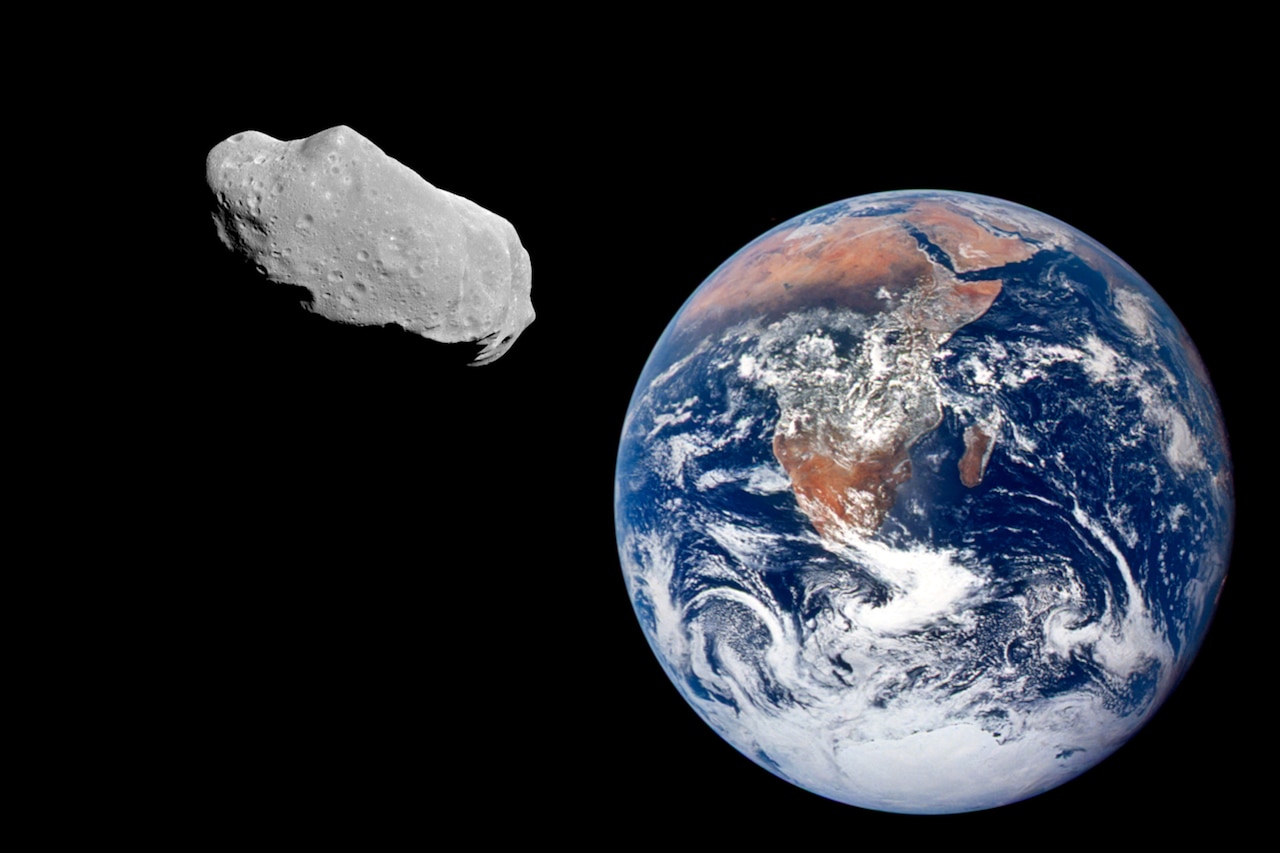 A large rock floats in space above the Earth.